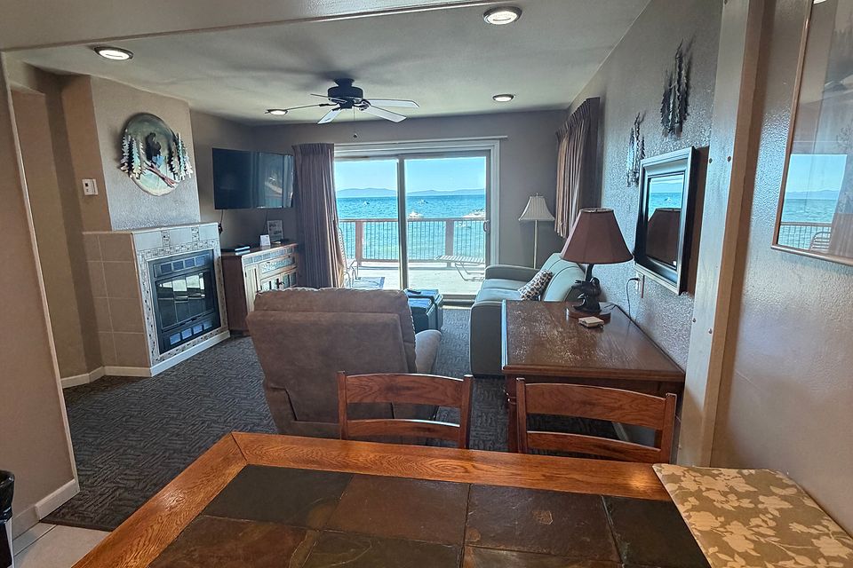 Living room with a tiled fireplace wall, Unit J